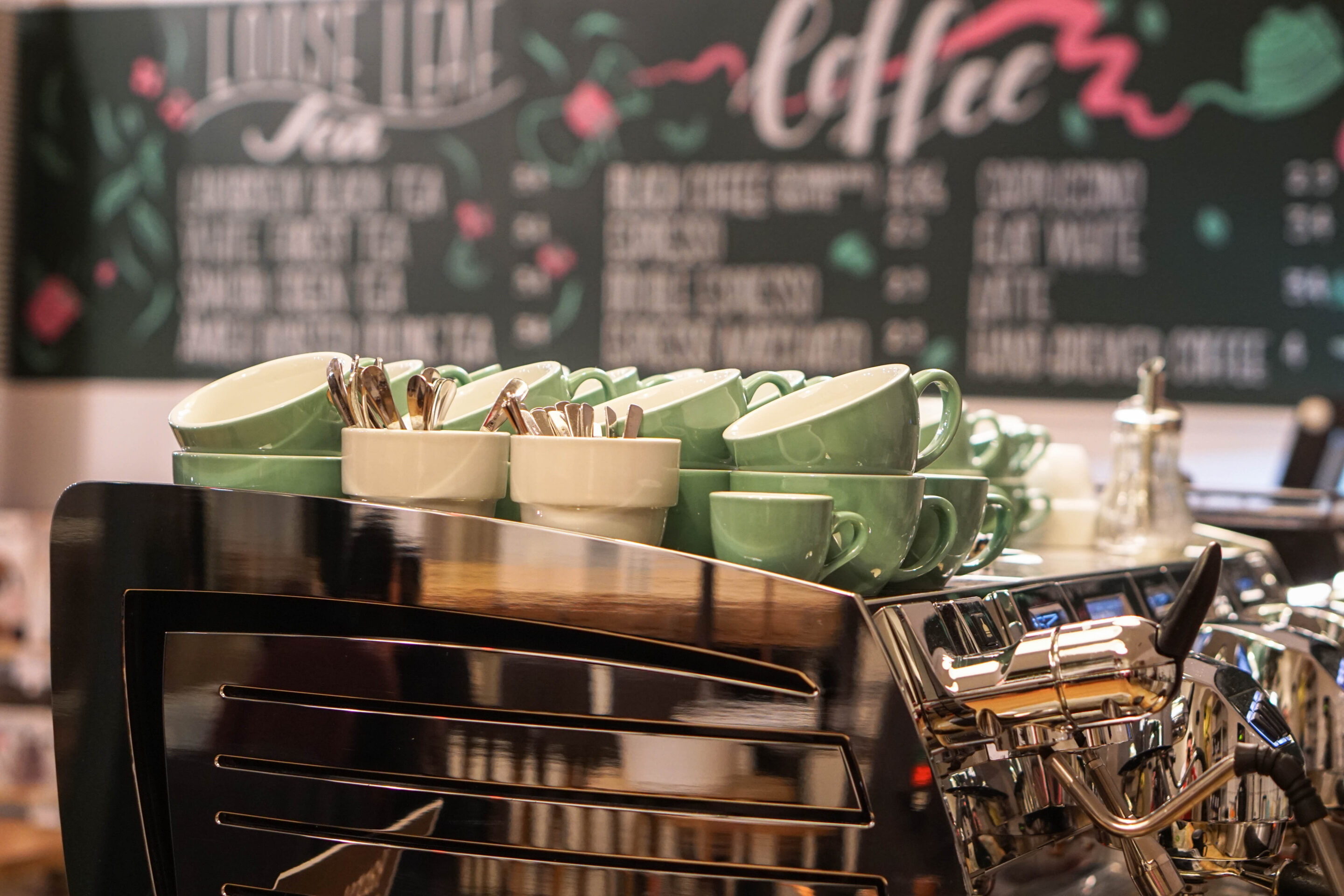 Espresso machine with menu in the background