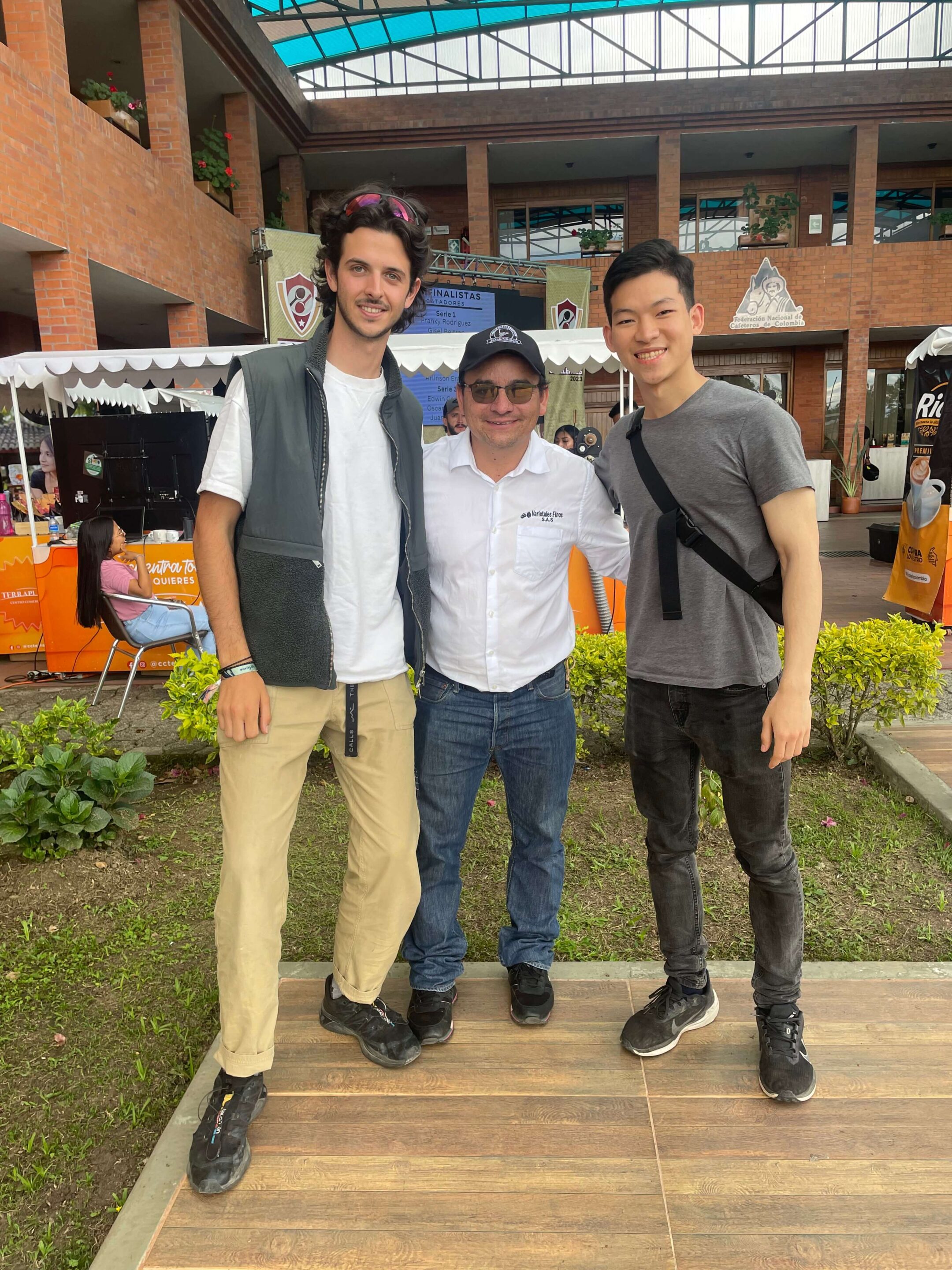 Three men standing together facing the camera