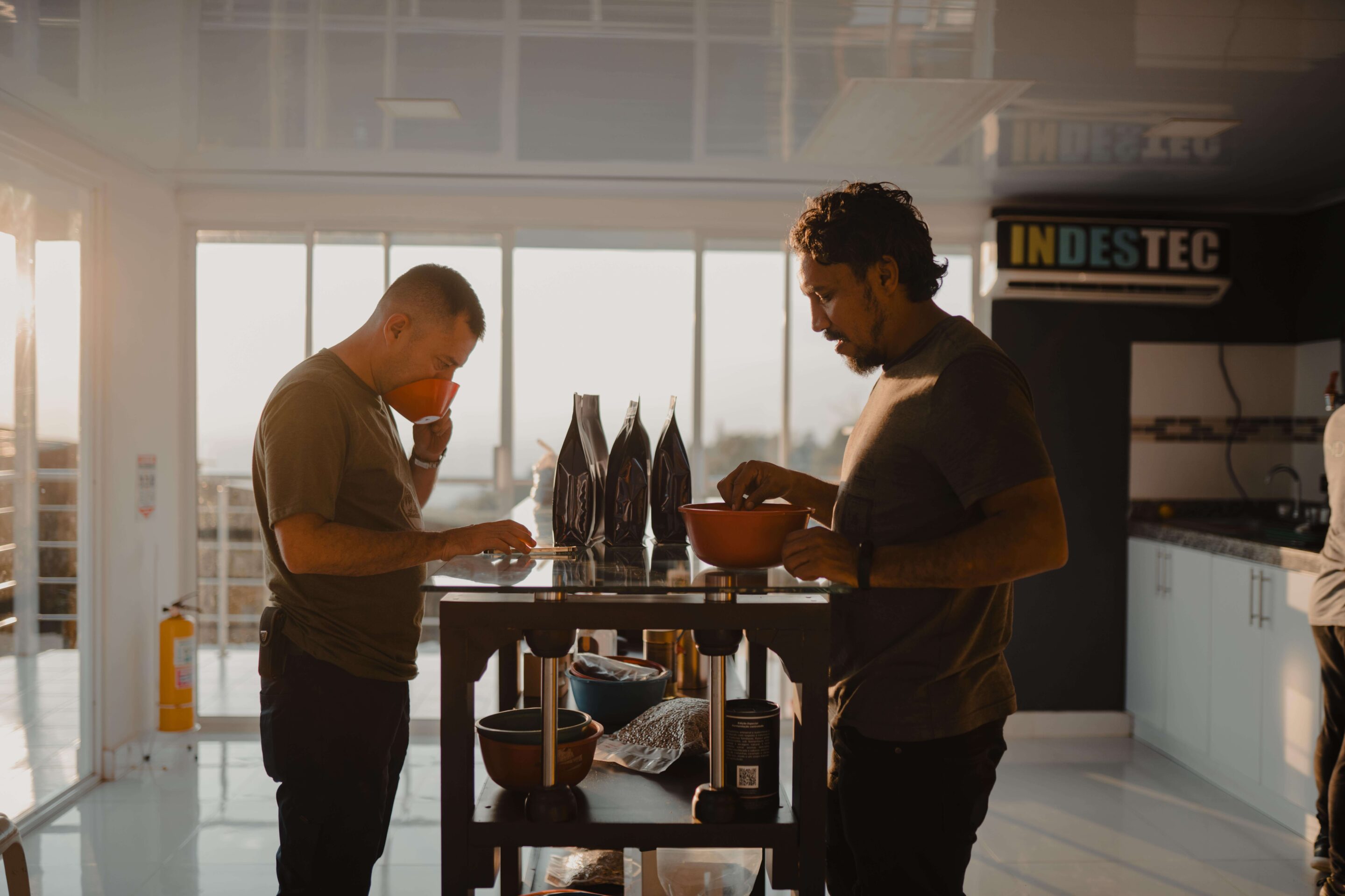 Two men standing in a coffee lab