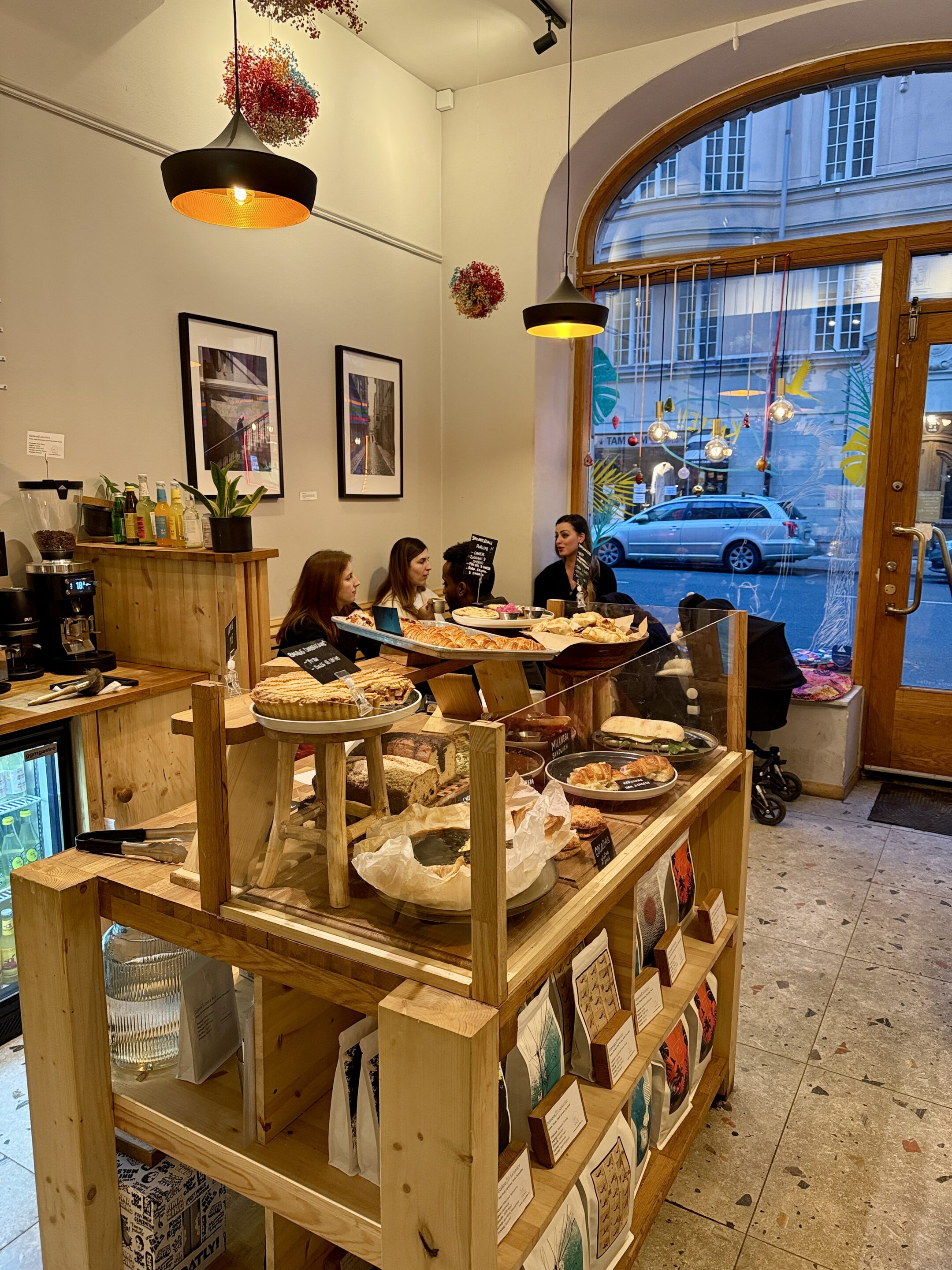 View of a coffee shop interior with a shelf displaying food