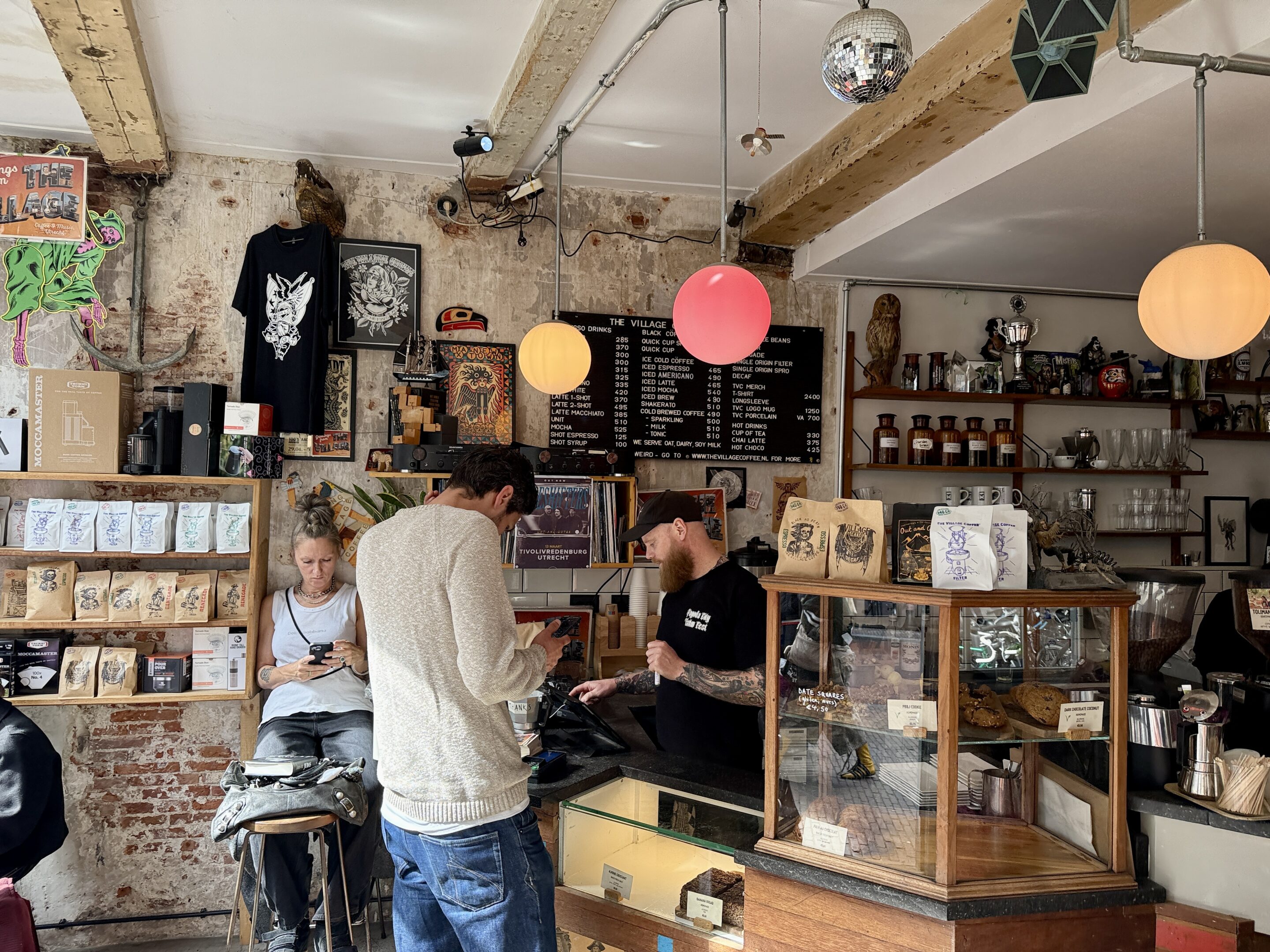 View of a coffee bar with various people in view.