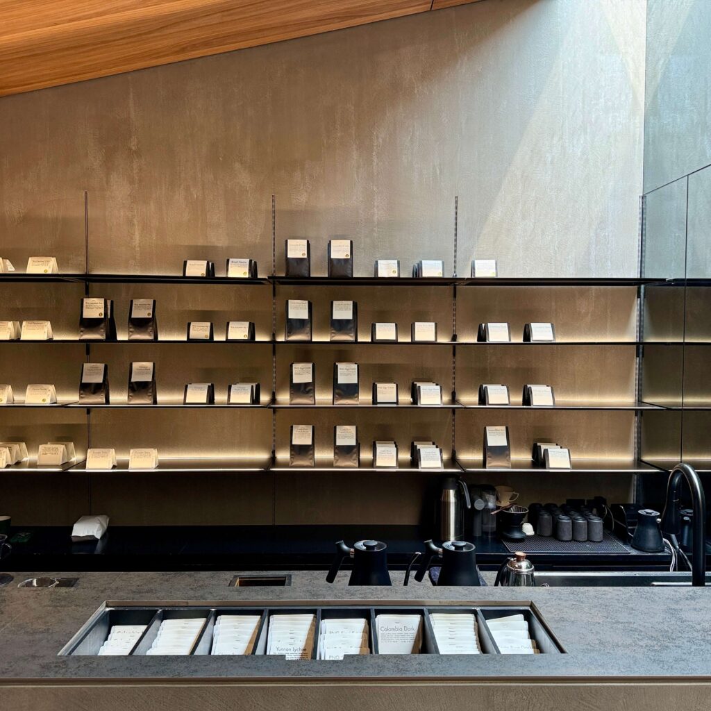 High end retail shelf with coffee bags and a coffee counter