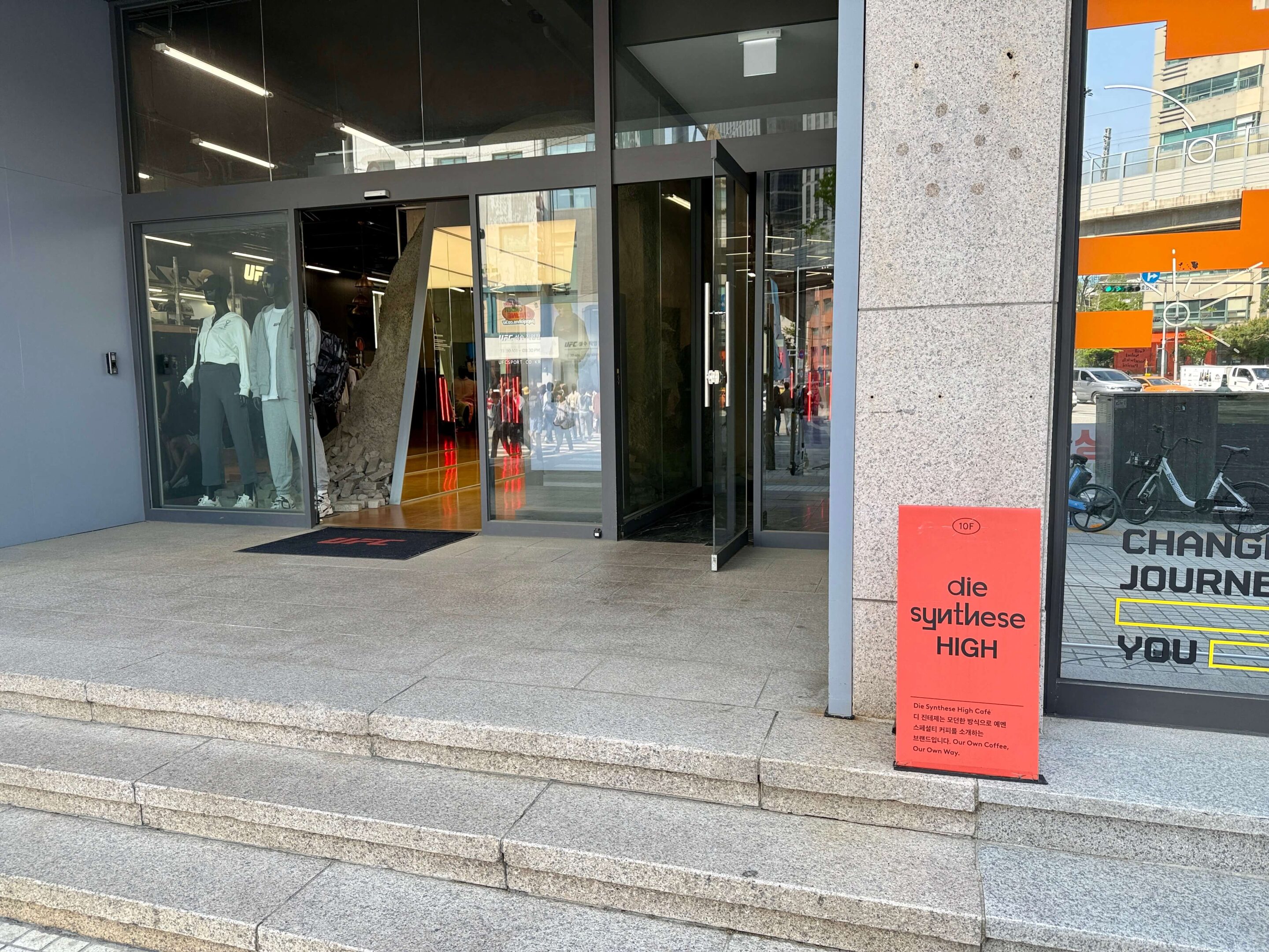 Building entrance with a bright red sign outside