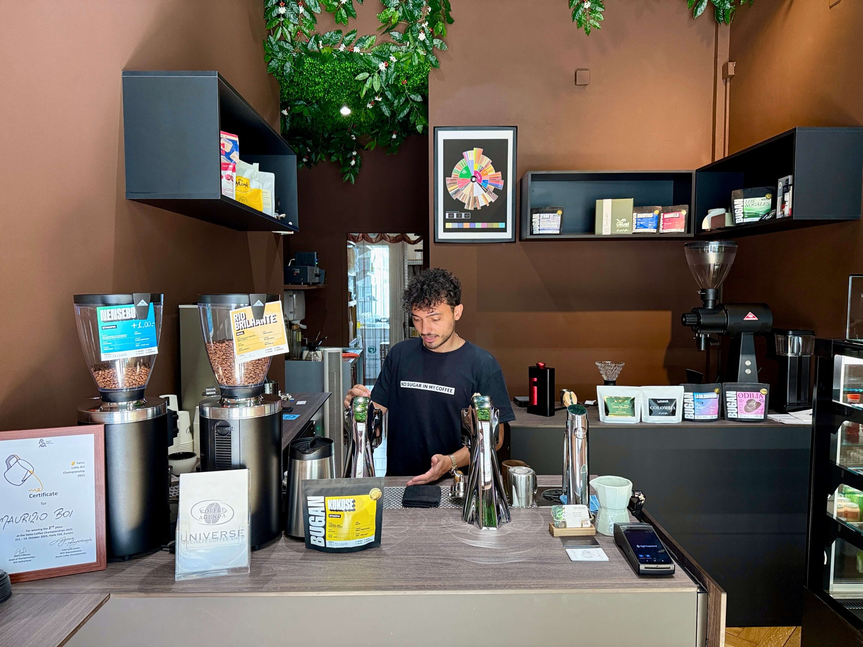 View of a coffee bar with the barista at work behind the counter
