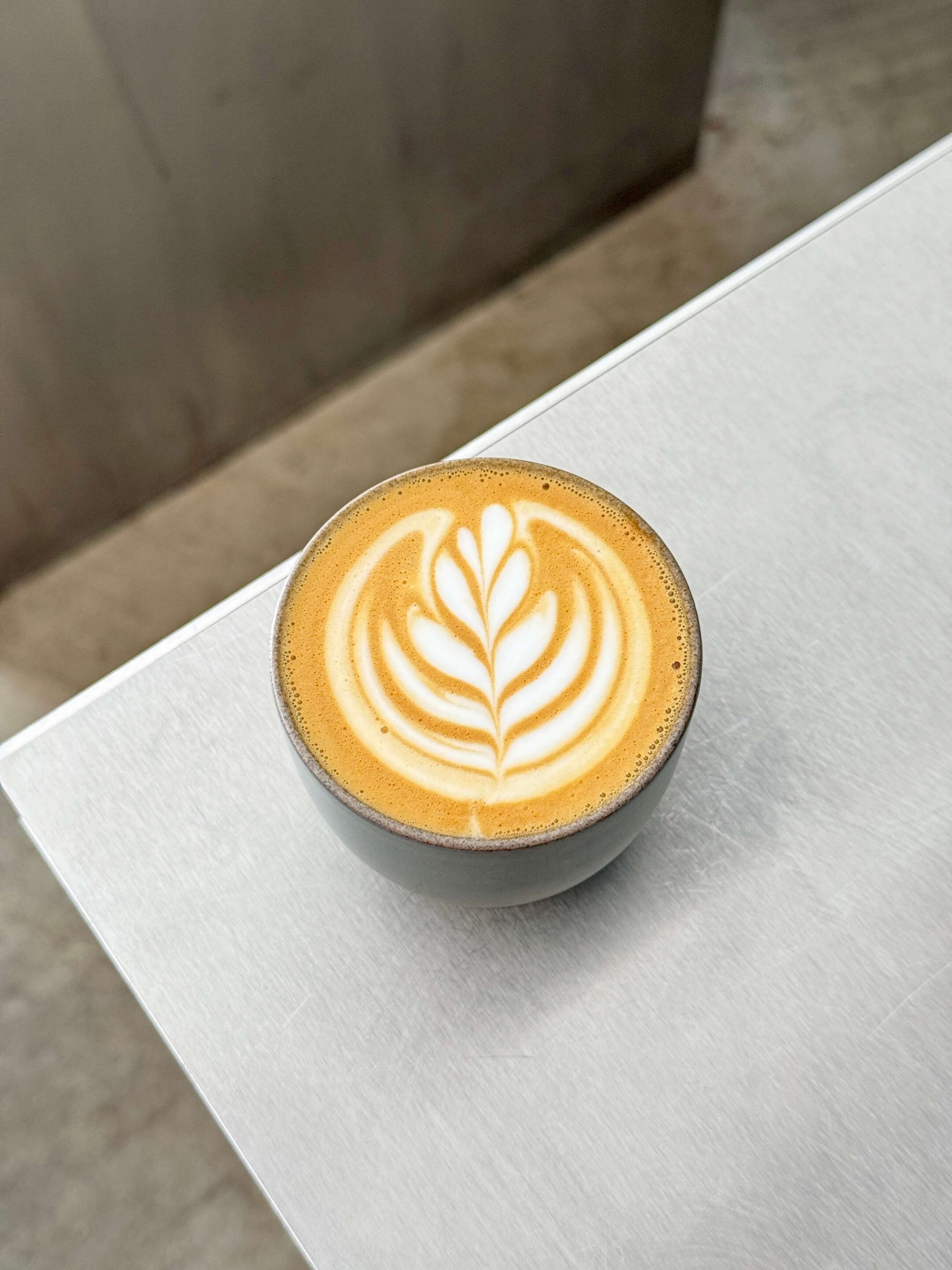 Top down view of a flat white with tulip latte art