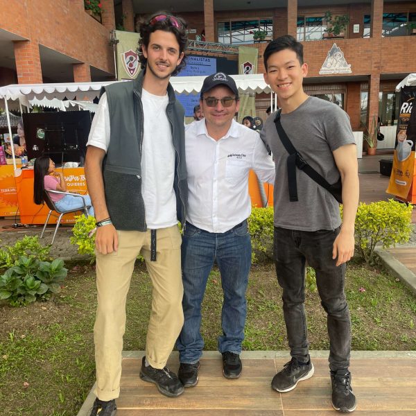 Three men standing together facing the camera